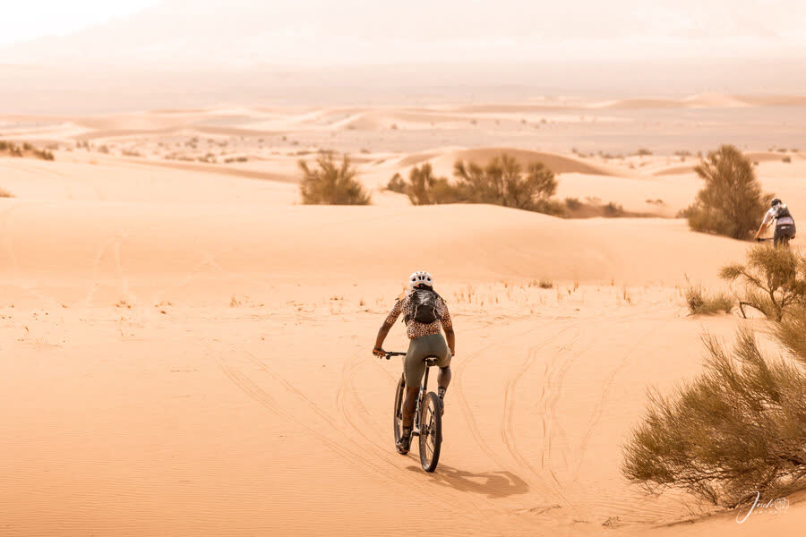 Otto riding through the Sahara desert dunes