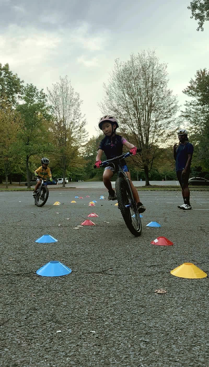 Child practicing a cone drill on a mountain bike
