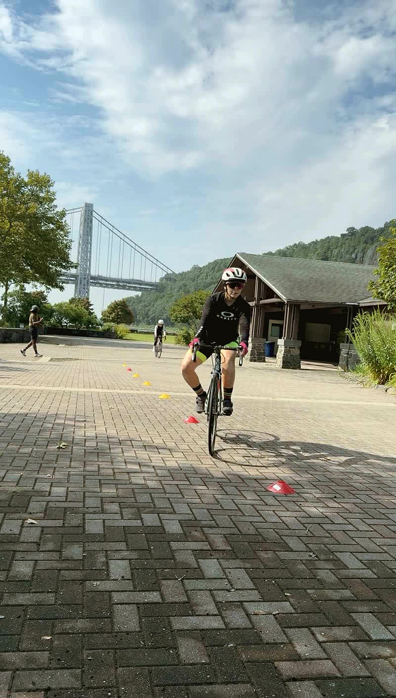 Cyclist training near Route 9W with the George Washington Bridge in the background